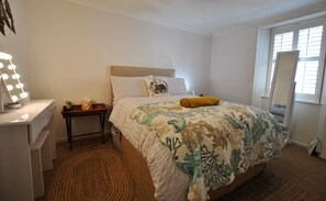 The double bedroom has a calm coastal theme