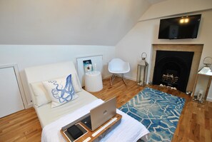 On the top floor, this additional lounge evokes loft house vines