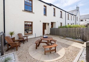 Enjoy the sunshine in the enclosed courtyard garden with furniture
