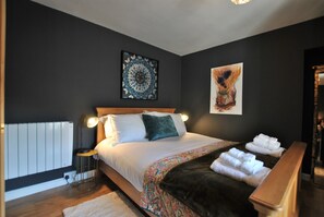 The bedroom is decorated in rich tones