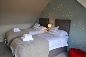 The upper twin room features bean bags and TV ideal for a chillout area