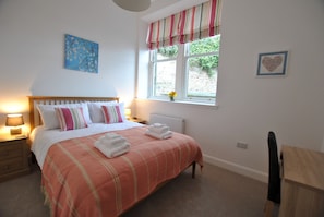 The front bedroom is relaxing and homely with high quality bed linen

