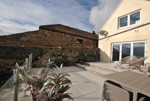 The terraced courtyard sits on the seafront