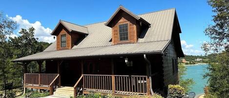 Welcome to the entrance of a genuine log cabin on Douglas Lake. This cabin has 3K sq ft of interior space, 1Ksq ft of porch space, and 2K sq ft of patio space. This cabin is on 3.8 acres and is close to Dollywood, Pigeon Forge, and Gatlinburg