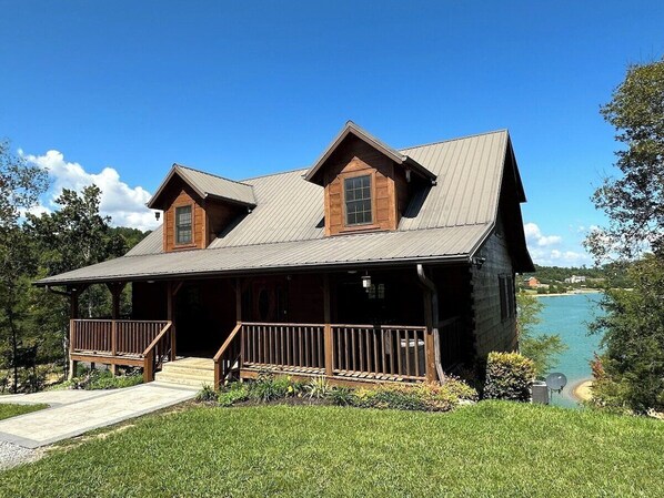 Welcome to the entrance of a genuine log cabin on Douglas Lake. This cabin has 3K sq ft of interior space, 1Ksq ft of porch space, and 2K sq ft of patio space. This cabin is on 3.8 acres and is close to Dollywood, Pigeon Forge, and Gatlinburg