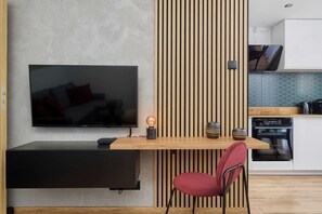 A modern TV unit with a slatted wooden wall accent, adding sophistication to the space.
