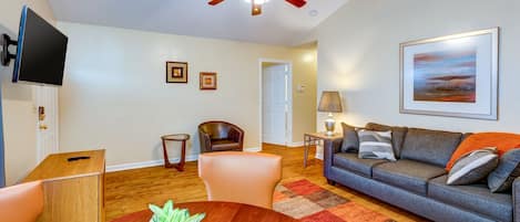 Cozy living space with sofa sleeper, table, and TV