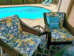 Lanai furniture by the pool and spa