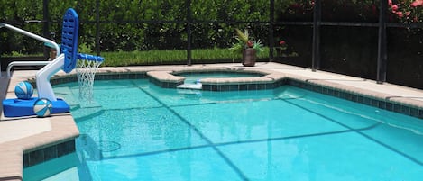 Pool and spa area with screened pool cage