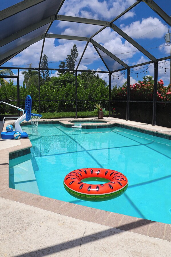 Pool and spa area with screened pool cage
