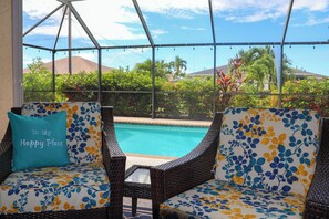 Lanai furniture by the pool and spa