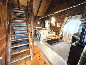 Living room with steps to loft