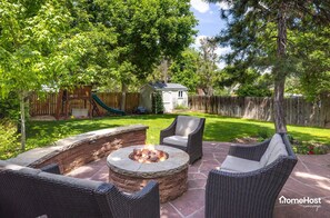 Spacious outdoor seating with fire pit — cozy up!