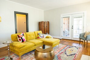 Living room with view to screened in porch.