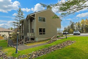 The homes patio and ample windows with view of parking area.