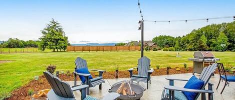 Relax and enjoy the view of the Olympic Mountains on the 450 sq. ft. patio with Adirondack chairs, dining table, fire pit, and BBQ. The large lawn offers endless fun with games like Bolo Toss, Cornhole, Baci, and Croquet. Book your stay now!
