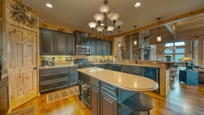 Spacious kitchen with bar stool seating.