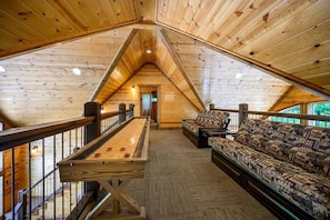Ascend the staircase to discover an inviting upstairs den, a secluded retreat perfect for relaxation or intimate gatherings.