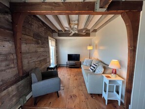 Charming living room with smart TV, deck access and queen pull out sleeper couch