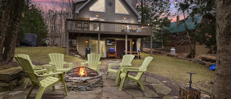 Relax outdoors with a fire pit, Adirondack chairs, outdoor TV, and scenic views.