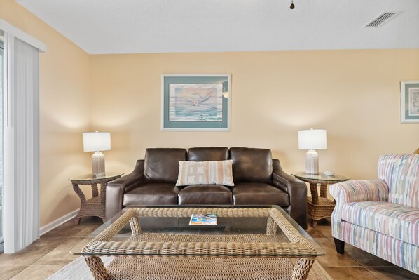 Spacious living room with a sofa and accent chair.