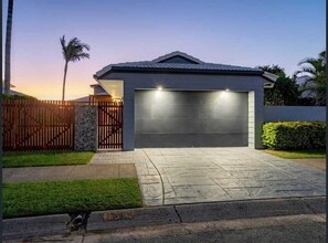 Entrance to the house with garage door and car port for 2 cars