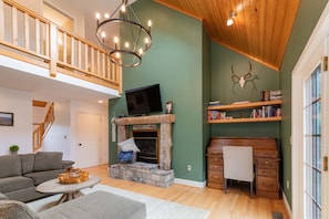 Main Level Living Room boasts vaulted ceilings with lots of natural light