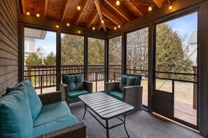 Fully enclosed, cozy and bright 3-season porch, with a rustic yet modern feel.