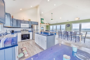 Plan and prep your family's meals in a spacious kitchen with stainless steel appliances, plentiful cabinets, and counter with 2 stools.