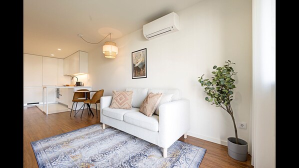Gorgeous main area, with a comfortable couch, dining area and a lovely kitchenette #modern #stunning