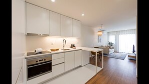 The kitchenette includes an electric kettle, an oven, a stove, Nespresso coffee machine, toaster and even a dishwasher #kitchen #lovelystay