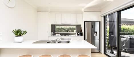 Our property's light-filled kitchen is a true gem, offering a perfect blend of style and functionality, making it a joy to prepare meals or simply unwind.