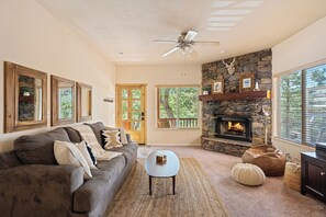 Living room with fireplace and TV with Roku. Sofa pulls out into a queen bed.