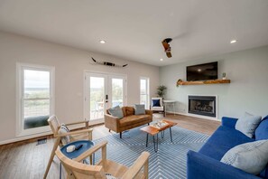 Living room off kitchen with lake views, gas fireplace, and Smart Roku TV