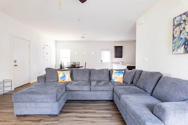 Unwind in our cozy living room, designed for relaxation and entertainment with its inviting ambiance and comfortable seating.