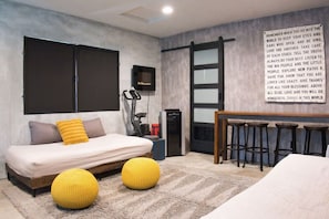 Versatile Urban Retreat - Relax on a twin bed sofa or catch the latest series on a 65" Smart TVin this dynamic space that serves as your personal theatre, bedroom, and gym, all set against theinspiring backdrop of Utah Tech.