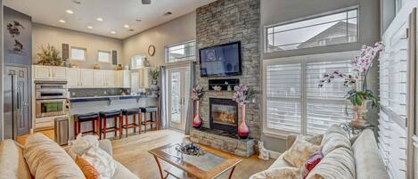 Family room with gas fireplace and large TV.