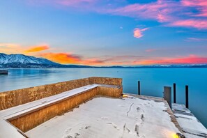 Lakefront Level grounds with lawn and stately Sierra trees lead to 100' of breathtaking shoreline with a private pier and two Boat buoys