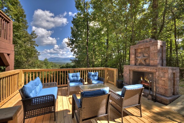 Relax around the outdoor fireplace and take in that huge North Georgia Mountain View!