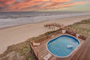 The two houses each have a beachfront lot and a private pool.