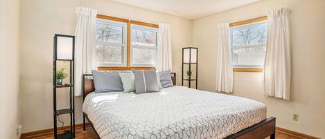 King bed with lamps to let you read and settle down at night. A closet with hangers and a dresser is also in this room.