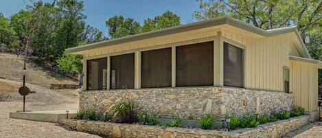 Guadalupe River rock accent wall. Screened porch with no afternoon sun.