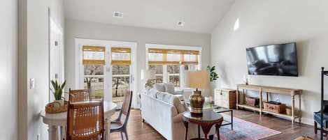 Living room with door to balcony.
Smart TV and small dining table.