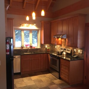 Kitchen w/ heated tile & granite countertops