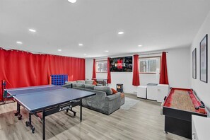 **Game Room** Unleash your family's competitive spirit in our game room! Ping pong, shuffleboard, and comfy seating all come together to create the ultimate entertainment space. Fun for the whole family, all in one place!