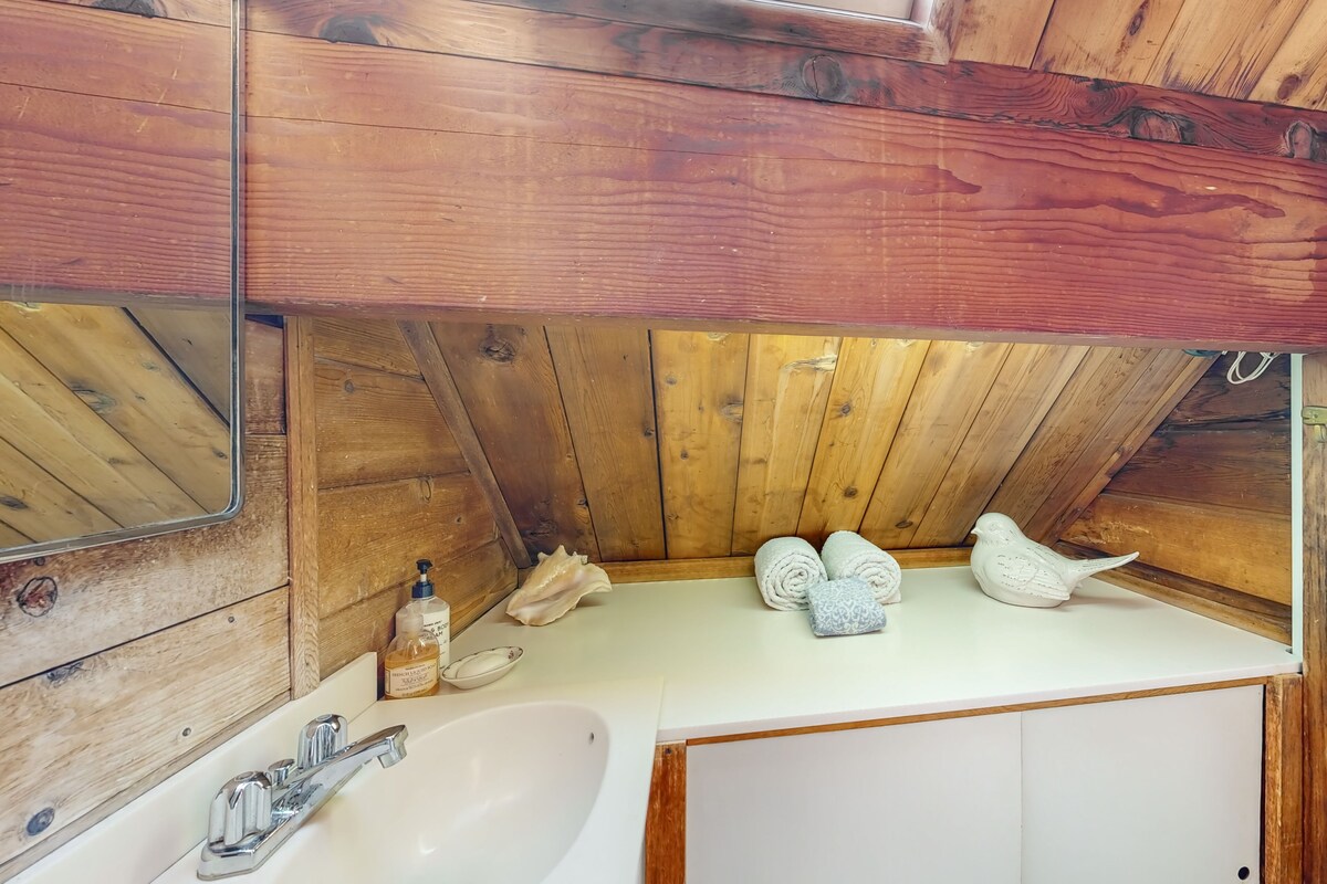 Water-view home with large deck, balcony, enclosed sunroom & peaceful location