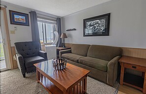 The sleeper sofa in the cozy living room accommodates two people for additional sleeping capacity.