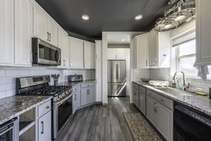 Full Kitchen with gas range, wine fridge, dish washer, & garbage disposal.