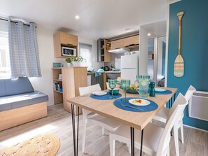 Bright and welcoming dining area with coastal decor, ideal for family meals and gatherings.