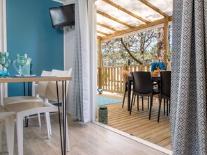 Inviting indoor-outdoor transition space, providing a comfortable spot to relax and dine.